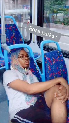 a woman sitting on a bus with her legs crossed and head wrapped around the seat