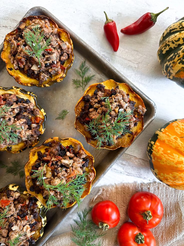 some food that is sitting on a pan next to tomatoes and other foodstuffs