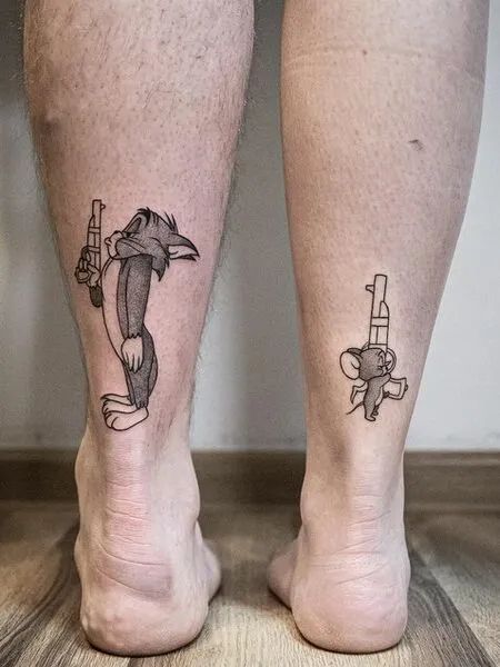 two people with matching tattoos on their legs