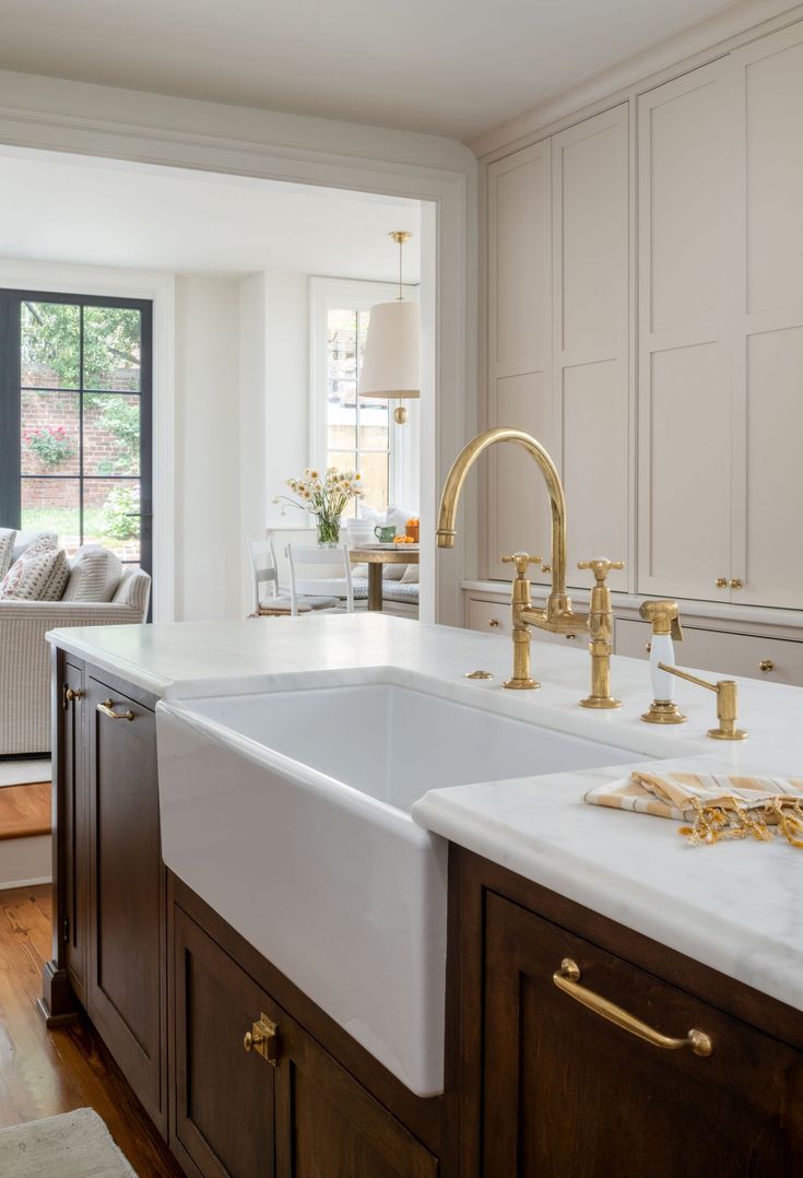 a kitchen with white counter tops and wooden cabinets