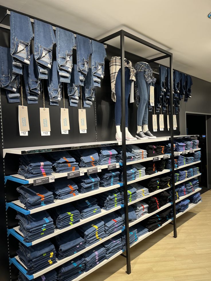 the shelves are filled with different types of jeans