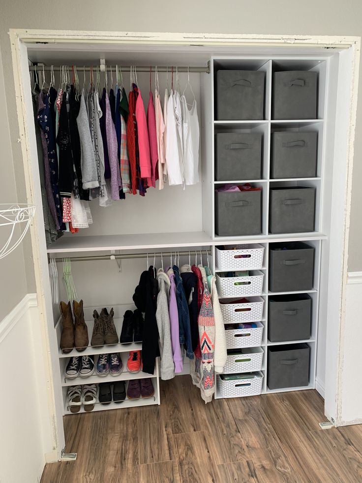 an organized closet with clothes and shoes