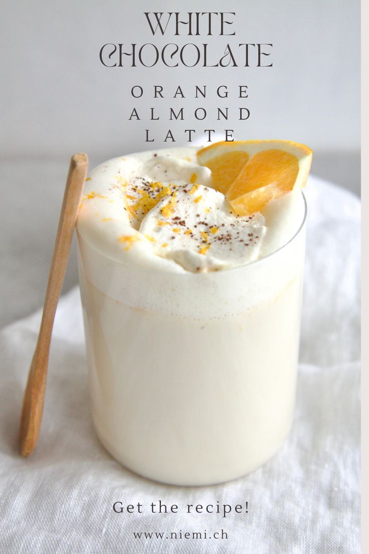 an orange and almond latte is garnished with whipped cream