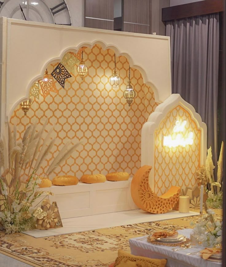 an elaborately decorated stage set up for a wedding or special event with white and gold decor