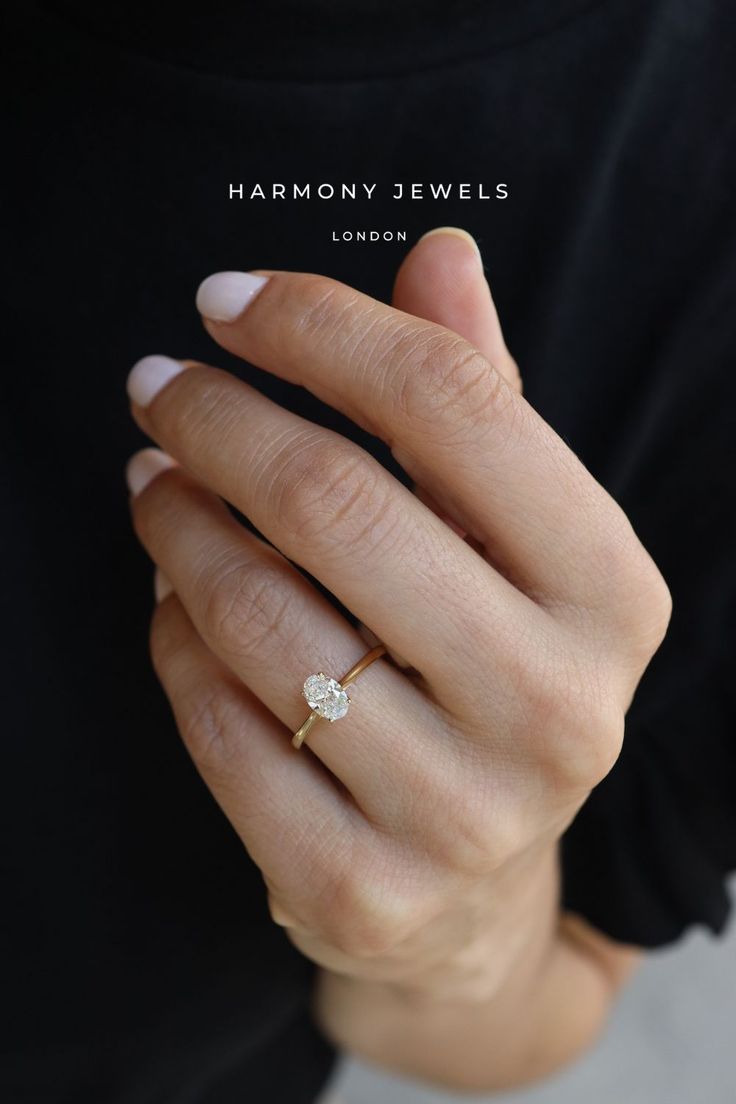 a woman's hand with a diamond ring on her left hand and the words harmony jewels