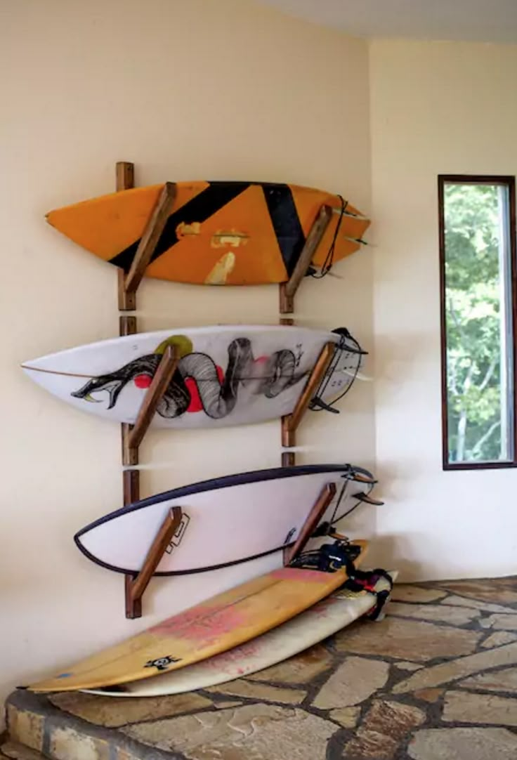 three surfboards are hanging on the wall