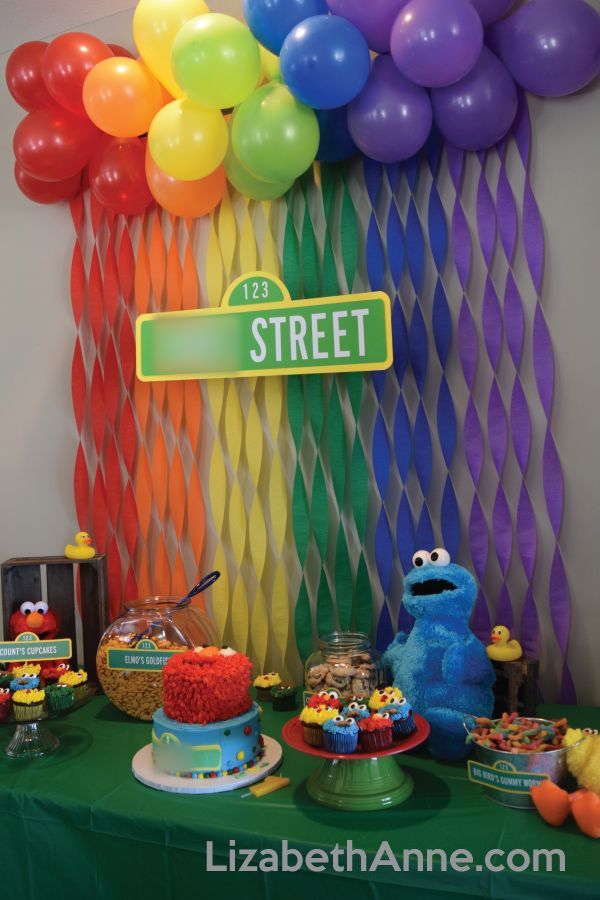 a sesame street birthday party with balloons and cake