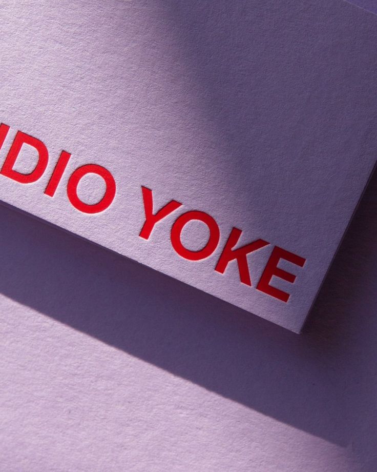 the word radio yoke is placed on top of a piece of paper with red lettering