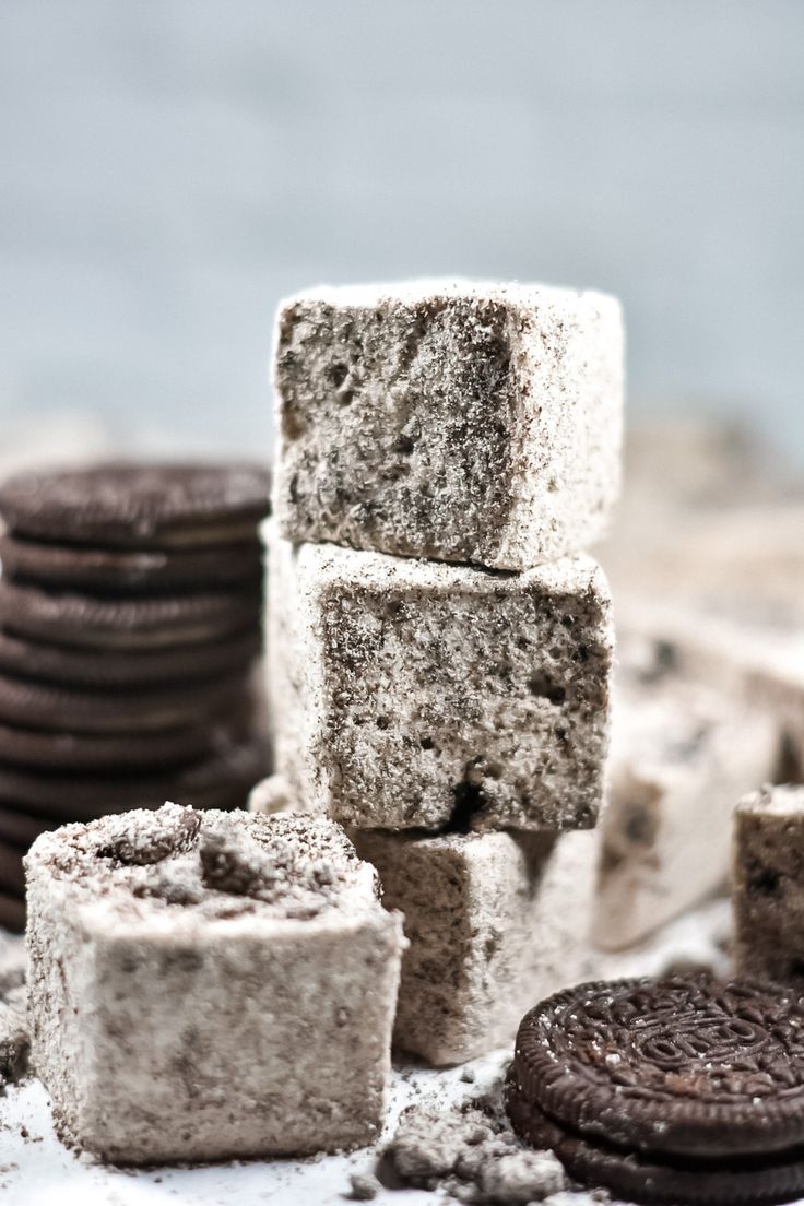 oreo cookies and marshmallows are stacked up next to each other on a table