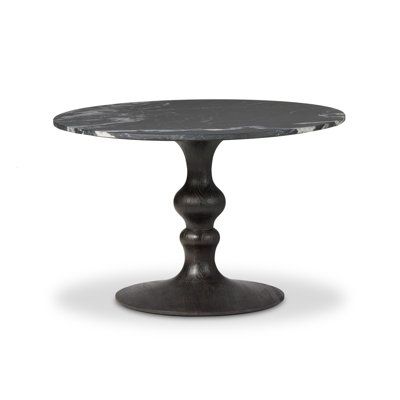 a round table with black marble top on an isolated white background for use as a dining room or office space