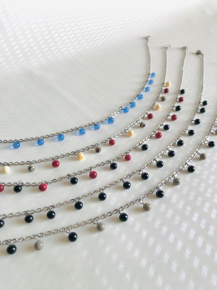 Here is the "Hanging Pearls" choker necklace collection. 🔥 Each bead is handcrafted by me. I work on glass bars in a very hot flame to shape the glass to suit your needs. It's called glass spinning Received idea : Glass beads are fragile: No! The spherical and small beads are very strong and bounce like marbles Practical information : 💧All metal elements are made of stainless steel. Thus, these jewels are not afraid of water and provide comfort and impeccable quality. 📏 The necklaces are adju Glass Beaded Necklaces With Dangling Beads As Gifts, Adjustable Choker With Dangling Beads, Adjustable Metal Crystal Necklaces With Round Beads, Dangling Beads Choker As Gift, Crystal Beaded Chain Choker Necklace For Gifts, Party Choker With Dangling Round Beads, Adjustable Polished Bead Choker As Gift, Polished Beads Choker Necklace For Gifts, Glass Necklaces With Tiny Beads For Jewelry Making