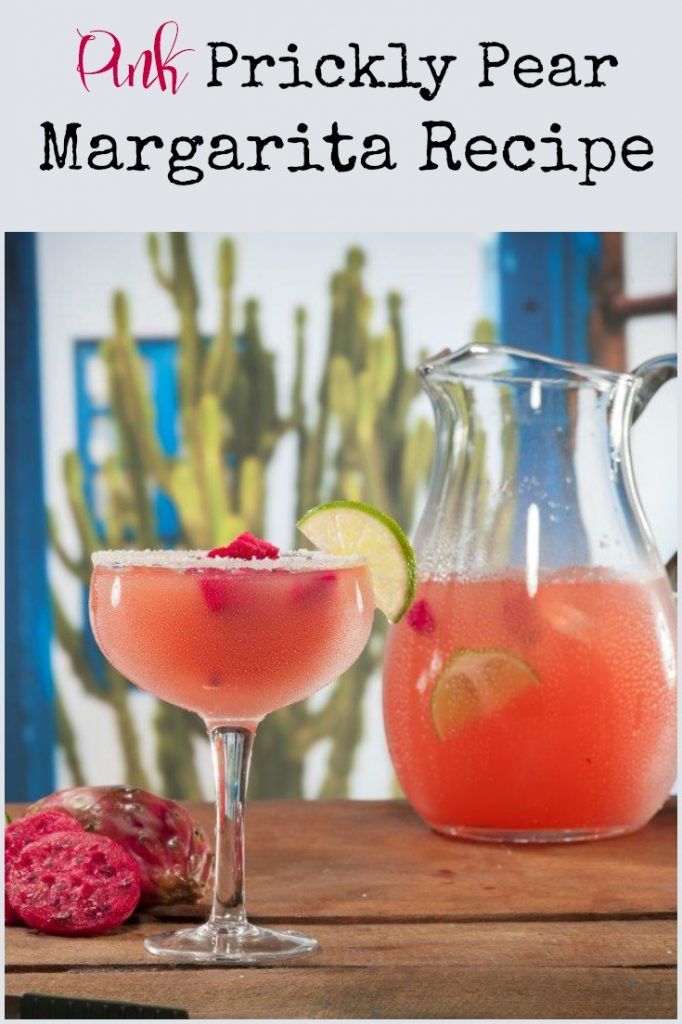 pink prickly pear margarita recipe with lime and raspberry garnish in a pitcher