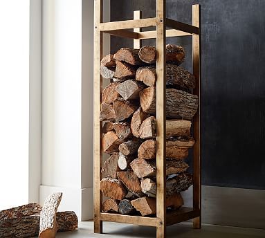 a stack of logs sitting next to a pile of wood on top of a floor