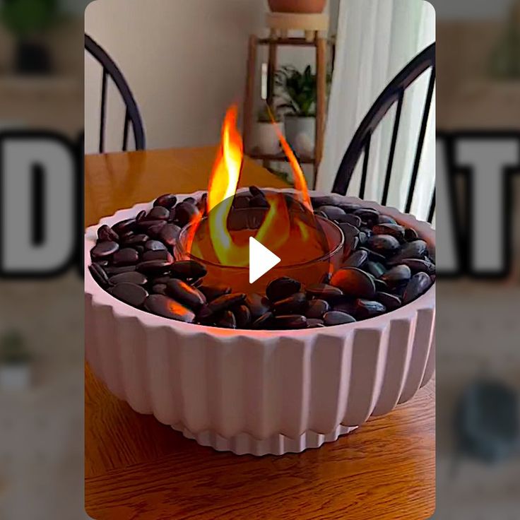 a fire pit sitting on top of a wooden table