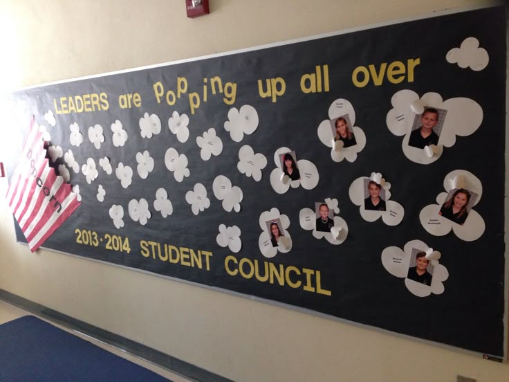 a bulletin board with pictures of people on it in a school hallway that reads leaders are going up all over 2013 student council