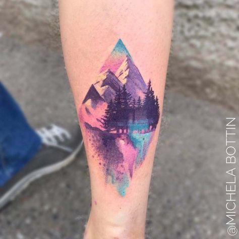 a person with a tattoo on their leg that has mountains and trees painted on it