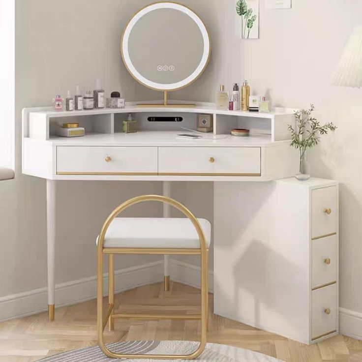 a white desk with a mirror and stool in front of it on a wooden floor