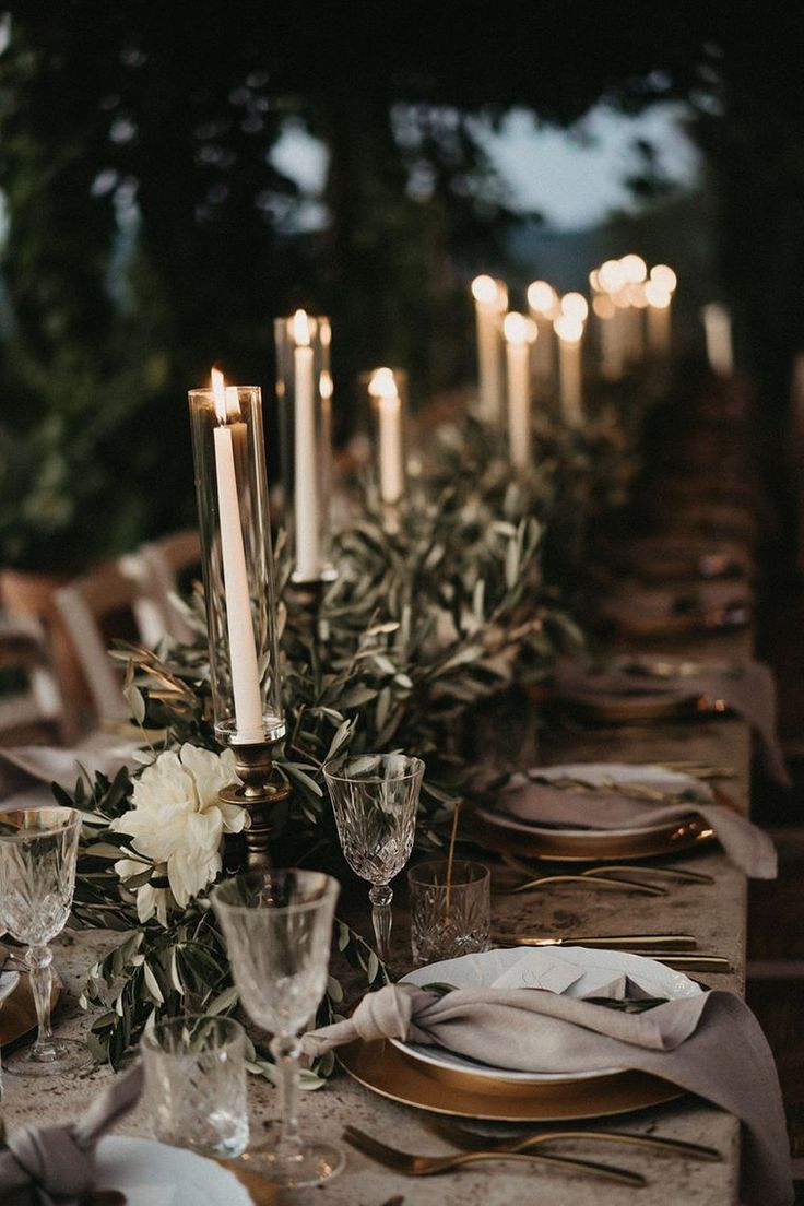 an elegant table setting with candles and flowers