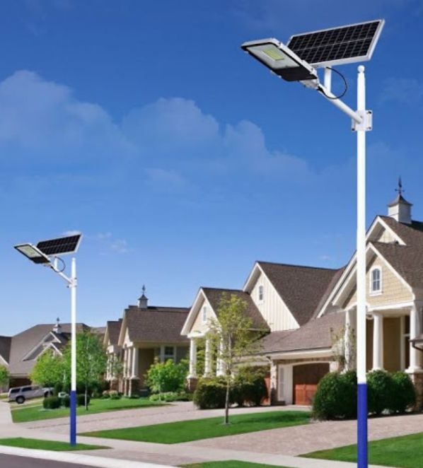 a row of houses with solar panels on the roof and street lights in front of them