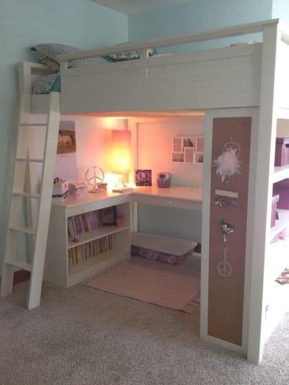 there is a loft bed with a desk underneath it and bookshelves on the bottom floor