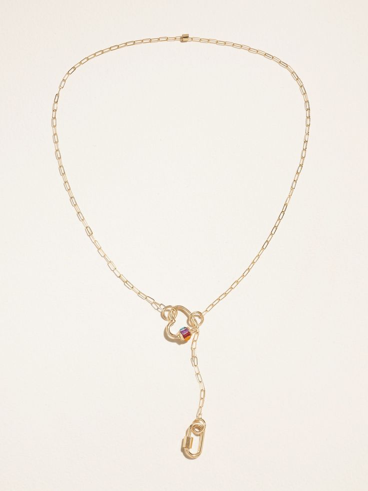 Marla Aaron's handcrafted jewelry is "designed to be worn in infinite ways," so let your imagination run free. This necklace is hand-cast from 14-karat gold, with a heart at one end and a signature lock at the other. Twist the multicolored charm to reveal a kaleidoscope of precious and semi-precious stones. Fine Jewelry Gemstone For Valentine's Day, Fine Gemstone Jewelry For Valentine's Day, Yellow Gold Heart-shaped Birthstone Jewelry, Fine Ruby Heart Jewelry, Fine Ruby Heart-shaped Jewelry, Elegant Ruby Heart Cut Jewelry, Elegant Heart Cut Ruby Jewelry, Valentine's Day Gemstone Fine Jewelry, Valentine's Day Fine Jewelry With Gemstones