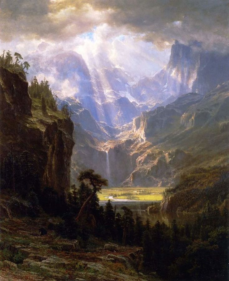 a painting of mountains and trees in the foreground, with sunlight coming through clouds