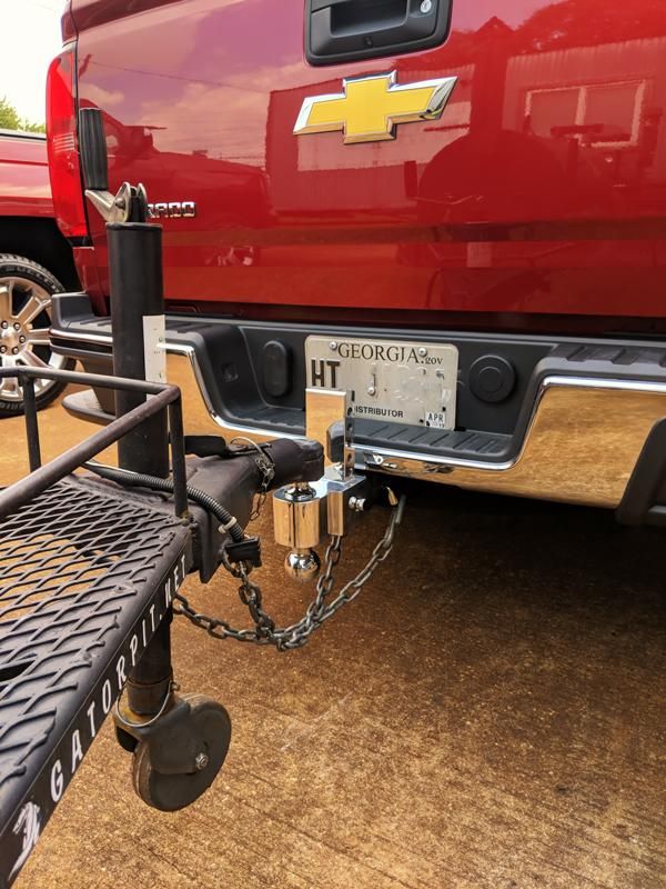 the back end of a red truck with a chain attached to it's bumper