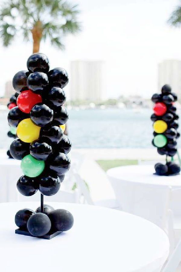 some black and white balloons sitting on top of a table