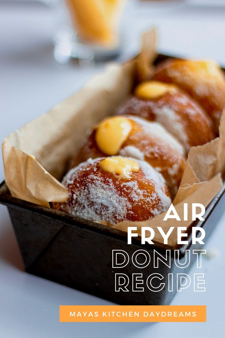 an air fryer donut recipe in a box with powdered sugar on top