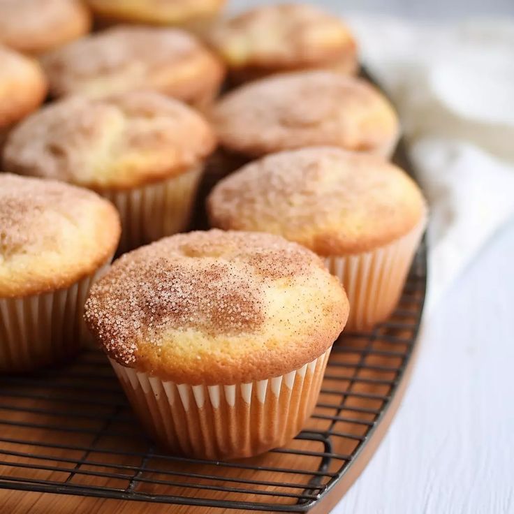 some sugared muffins are cooling on a wire rack