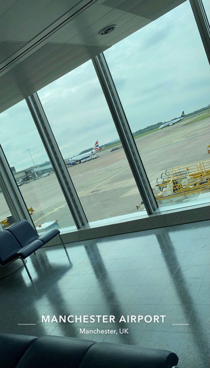 an airport terminal with large windows looking out onto the tarmac