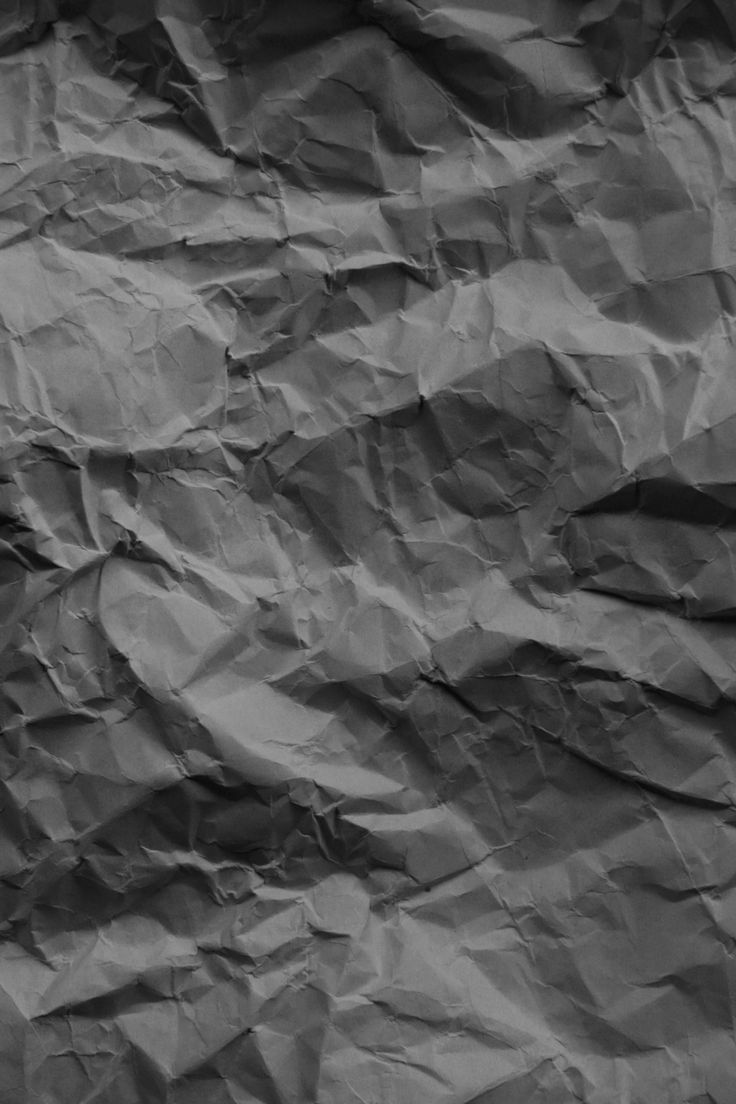 an abstract black and white photo of wrinkled paper