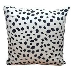 a black and white pillow with spots on it