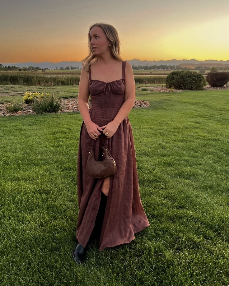 Somewhere out west ⛰️🌾🪵👢 #ootd #ootdshare #weddingguestdress #fallwedding #bohowedding #petitefashion #revolveme #westernfashion Wedding guest dress, farm wedding guest dress, fall wedding guest dress, brown maxi dress, western wedding guest dress, cowgirl boots, western dress, formal dress, fall fashion, petite fashion Country Winter Formal Dresses, Farm Wedding Guest Dress, Brown Midi Dress Outfit, Western Formal Wedding, Brown Maxi Dress Outfit, Cowgirl Wedding Outfit Guest, Wedding Guest Dress Brown, Formal Dress With Cowboy Boots, Western Wedding Guest Dress