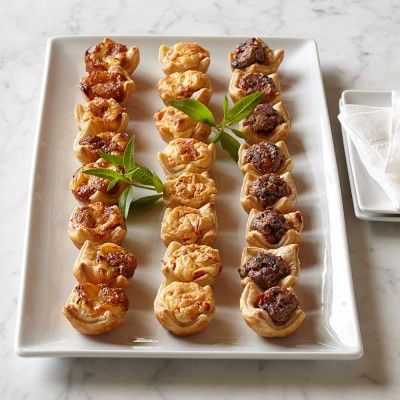 several appetizers are arranged on a white plate