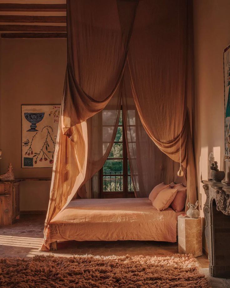 a bedroom with a canopy bed and rugs on the floor in front of it