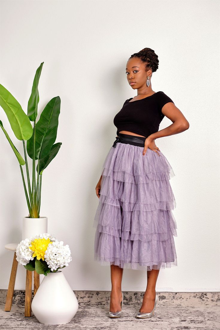 Channel your inner Southern belle in this midi-length multi-layer ruffle skirt with a stretchy waistband and waist tie. CONTENT & CARE Polyester Hand wash cold Do not bleach Iron low DEETS & FIT Model is wearing a size Small Fabric has no stretch Model profile: Uche is 5'9" and measures 34 (bust) 27 (waist) and 45 (hips) Spring Stretch Tiered Skirt, Spring Tiered Stretch Skirt, Spring Tiered Stretch Bottoms, Layered Hem Midi Skirt For Spring, Spring Tiered Tulle Skirt Bottoms, Spring Layered Hem Midi Skirt, Spring Tiered Tulle Bottoms, Fitted Ruffled Bottoms Midi Length, Spring Stretch Skirt With Layered Hem