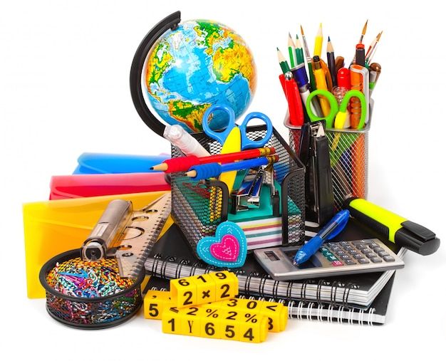 school supplies including pens, pencils, markers and a calculator on a white background