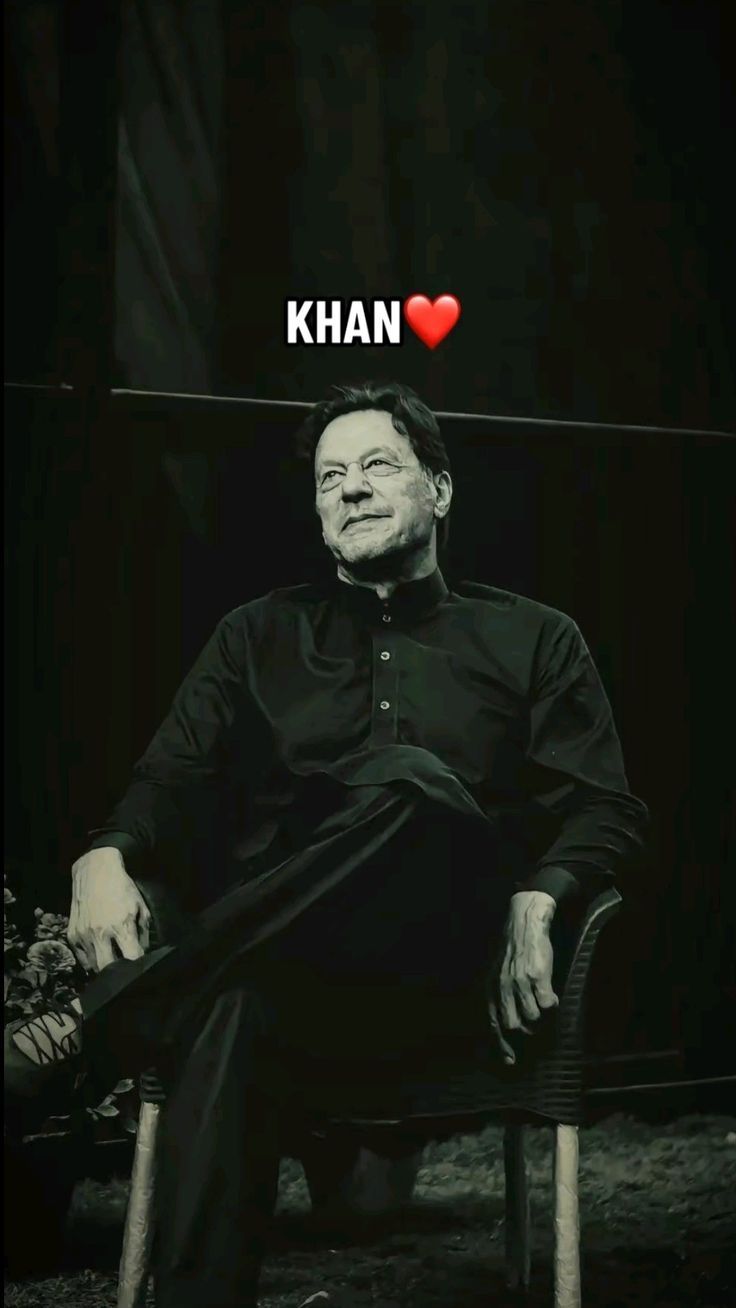 a man sitting in a chair with the words i love khan on it