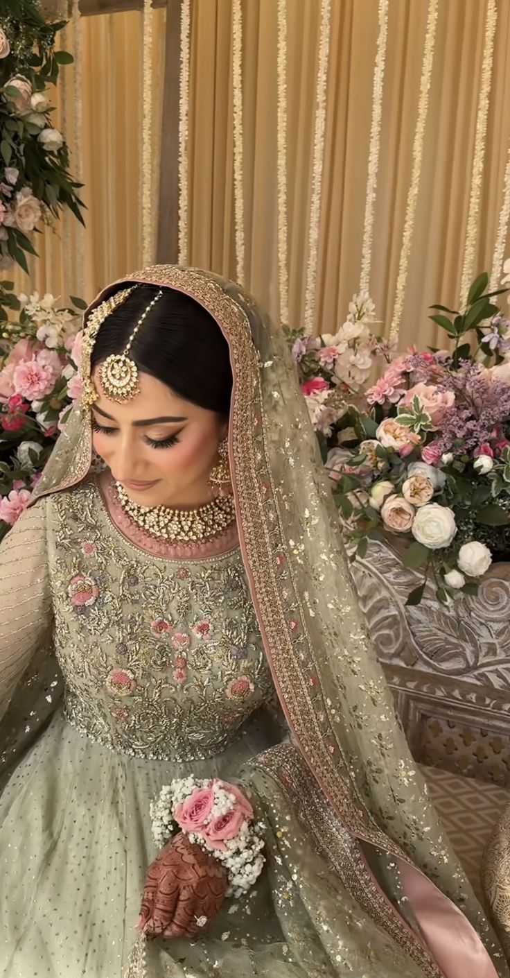 a woman in a wedding dress sitting down