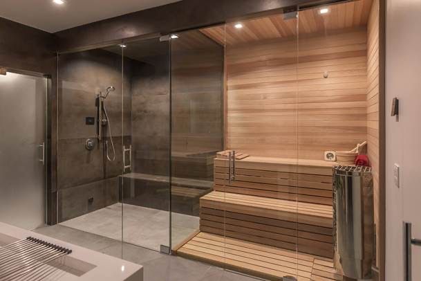 a bathroom with a wooden sauna and glass walls