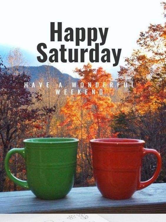 two coffee mugs sitting on top of a wooden table next to each other with the words happy saturday