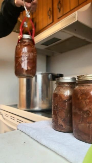 three jars filled with food sitting on top of a counter