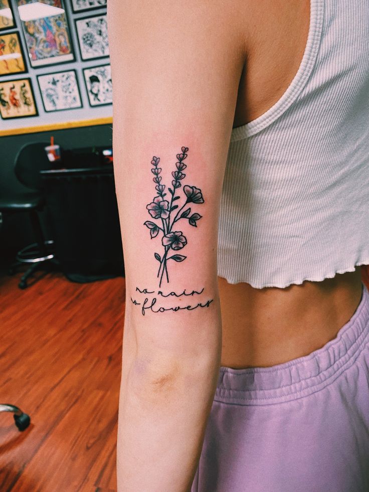 a woman with a flower tattoo on her arm