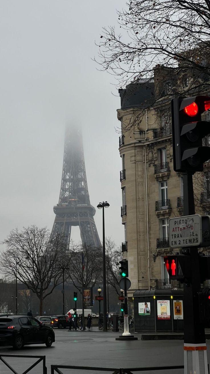 the eiffel tower is in the distance on a foggy, overcast day