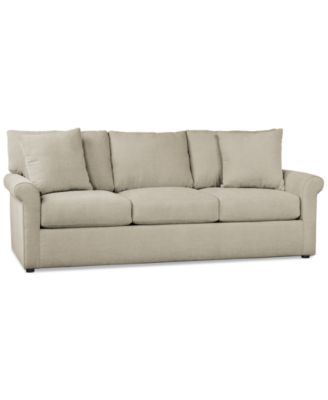 an image of a couch with pillows on the top and bottom half, in beige