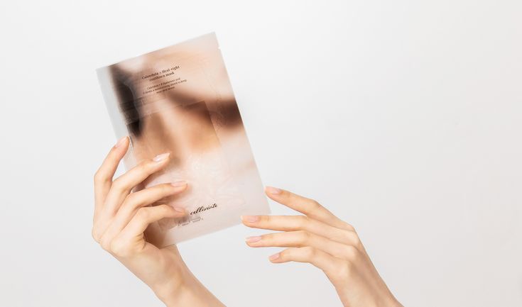 a woman holding up a book with her hands