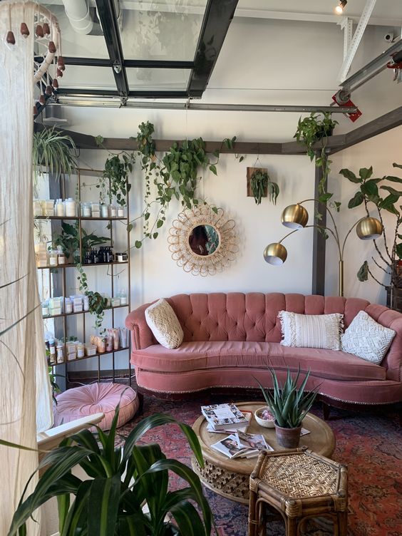 a living room filled with furniture and plants