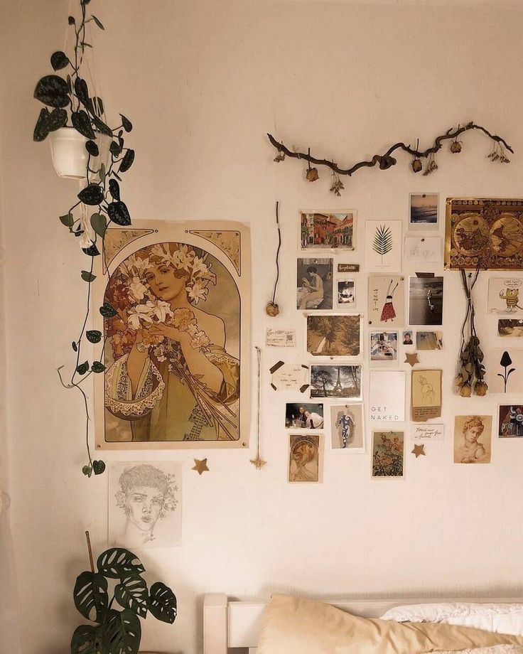 a bedroom with pictures and plants on the wall