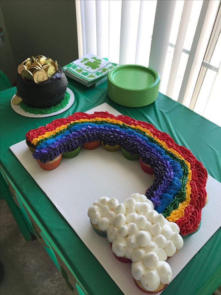 a rainbow cake with marshmallows in the shape of a number on it